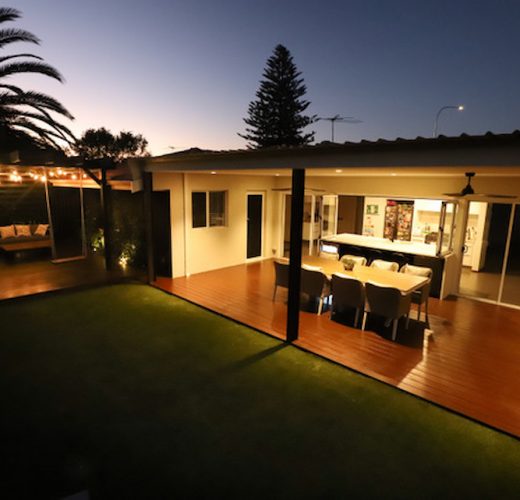 backyard renovation lit up deck after house extension